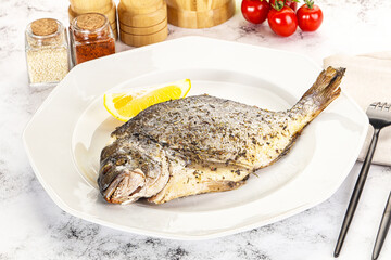 Baked Dorado fish served lemon