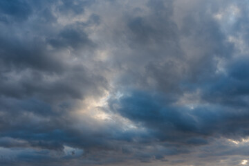 Dramatic clouds in a vibrant blue sky at dusk