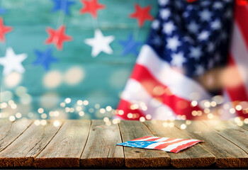 4th of July Independence Day background. Empty wooden plank table with American USA flag and...