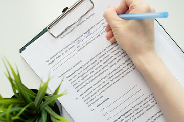 Intellectual property assignment agreement, hand fills out a document, trademark contract, brand...