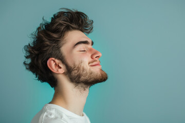 Obraz premium A close up of a man with beard and closed eyes looking to a side