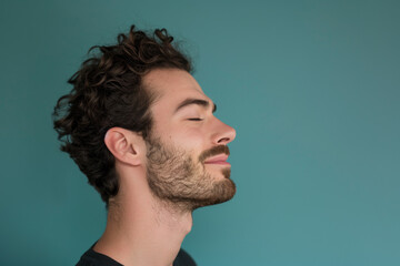 Fototapeta premium A close up of a man with beard and closed eyes looking to a side