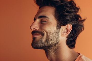 Fototapeta premium A close up of a man with beard and closed eyes looking to a side