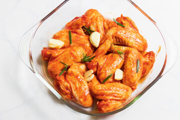 Marinated roast a spicy chicken wings with garlic and rosemary.