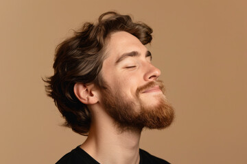 Fototapeta premium A close up of a man with beard and closed eyes looking to a side