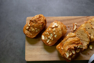 Baked peanut butter cake with nuts on wooden cutting board. Healthy and easy bake from air fryer.