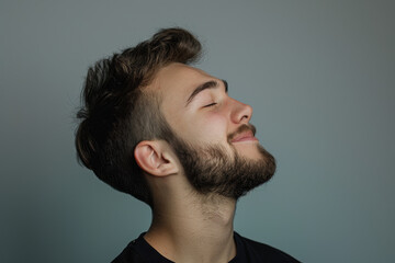 Obraz premium A close up of a man with beard and closed eyes looking to a side