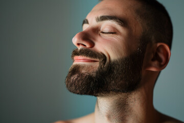Obraz premium A close up of a man with beard and closed eyes looking to a side