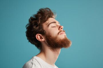 Fototapeta premium A close up of a man with beard and closed eyes looking to a side