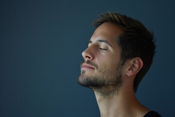 Obraz premium A close up of a man with beard and closed eyes looking to a side