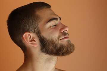 Fototapeta premium A close up of a man with beard and closed eyes looking to a side