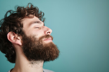Fototapeta premium A close up of a man with beard and closed eyes looking to a side