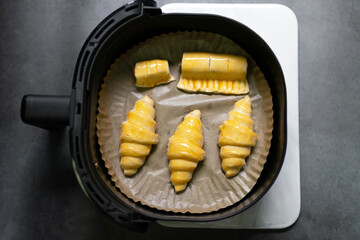 Pastry chef baking croissants and puff with air fryer; delicious and easy bake at home.