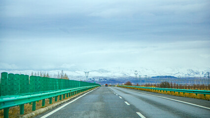 Haixi Mongolian and Tibetan Autonomous Prefecture, Qinghai Province - grasslands and roads under the snow-capped mountains