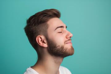 Fototapeta premium A close up of a man with beard and closed eyes looking to a side