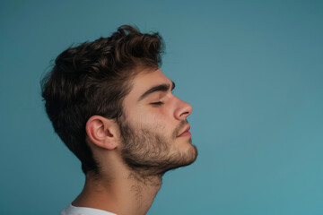 Fototapeta premium A close up of a man with beard and closed eyes looking to a side