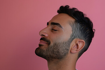 Obraz premium A close up of a man with beard and closed eyes looking to a side
