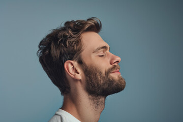 Fototapeta premium A close up of a man with beard and closed eyes looking to a side
