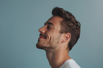 Fototapeta premium A close up of a man with beard and closed eyes looking to a side