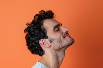 Fototapeta premium A close up of a man with beard and closed eyes looking to a side