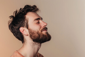 Fototapeta premium A close up of a man with beard and closed eyes looking to a side