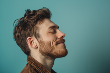 Fototapeta premium A close up of a man with beard and closed eyes looking to a side