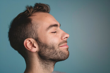 Obraz premium A close up of a man with beard and closed eyes looking to a side