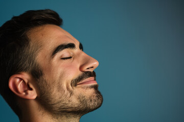 Obraz premium A close up of a man with beard and closed eyes looking to a side