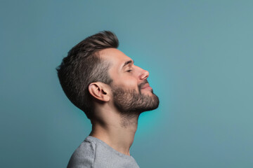 Obraz premium A close up of a man with beard and closed eyes looking to a side