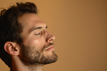 Obraz premium A close up of a man with beard and closed eyes looking to a side