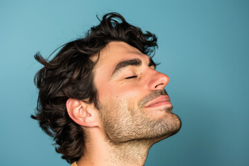 Obraz premium A close up of a man with beard and closed eyes looking to a side