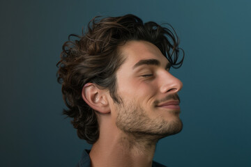Fototapeta premium A close up of a man with beard and closed eyes looking to a side