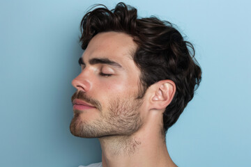 Obraz premium A close up of a man with beard and closed eyes looking to a side