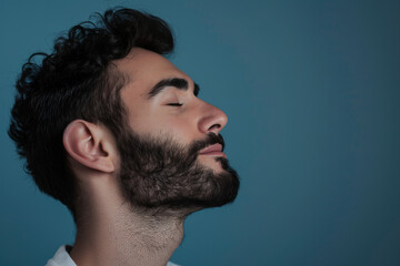 Fototapeta premium A close up of a man with beard and closed eyes looking to a side