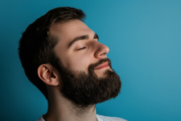 Fototapeta premium A close up of a man with beard and closed eyes looking to a side