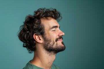 Fototapeta premium A close up of a man with beard and closed eyes looking to a side