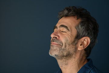 Fototapeta premium A close up of a man with beard and closed eyes looking to a side