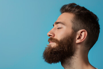 Fototapeta premium A close up of a man with beard and closed eyes looking to a side
