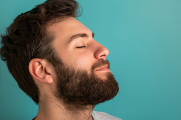 Fototapeta premium A close up of a man with beard and closed eyes looking to a side