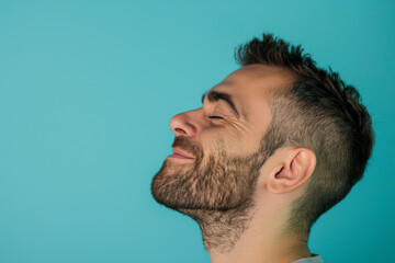 Obraz premium A close up of a man with beard and closed eyes looking to a side