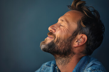 Fototapeta premium A close up of a man with beard and closed eyes looking to a side
