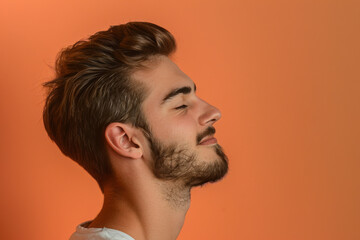 Fototapeta premium A close up of a man with beard and closed eyes looking to a side