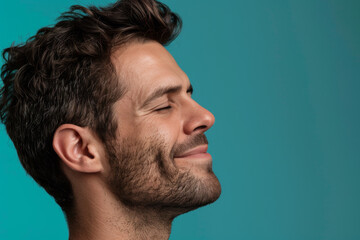 Fototapeta premium A close up of a man with beard and closed eyes looking to a side