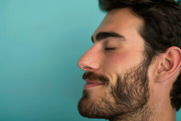 Obraz premium A close up of a man with beard and closed eyes looking to a side