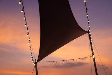 A large black tent with lights hanging from it