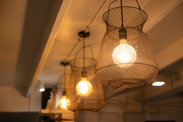 Three lighted lamps hanging from the ceiling