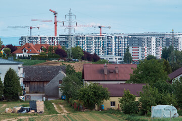 construction site with cranes, apartments and suburbs