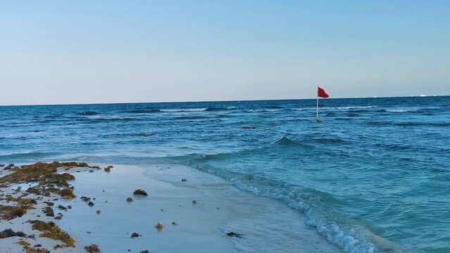 Red flag swimming prohibited high waves Playa del Carmen Mexico.