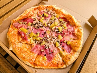 Pizza Mista to take away in a cardboard box