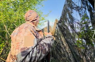 Hunter while hunting a wild bird. Hunters with gun and rifle on hunting. Hunters during duck...